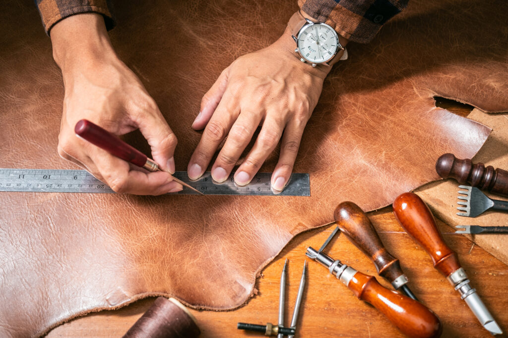 man working with leather